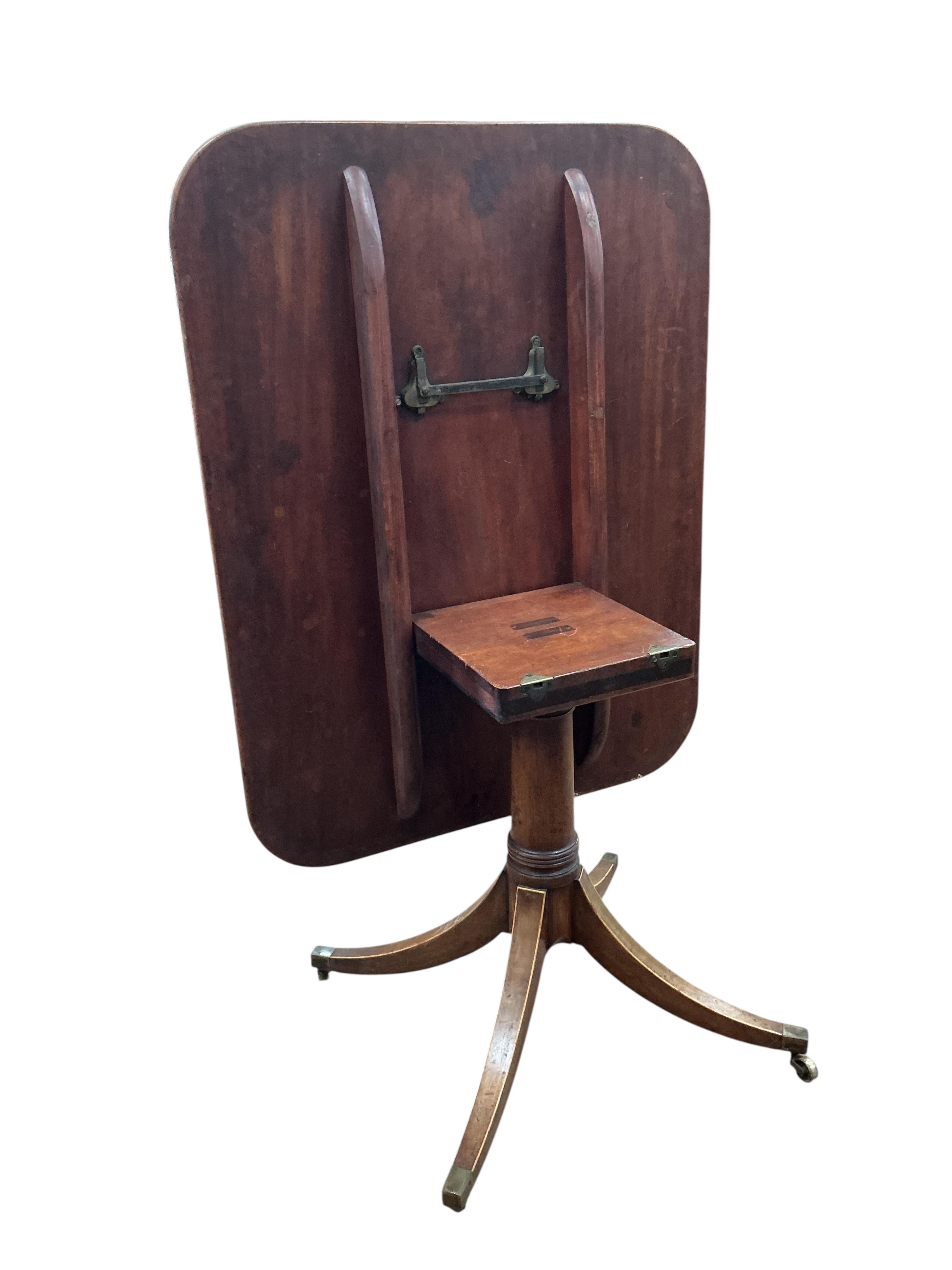 A Regency satinwood banded rectangular mahogany tilt top dining table, on four outswept legs, width 82cm, depth 104cm, height 72cm